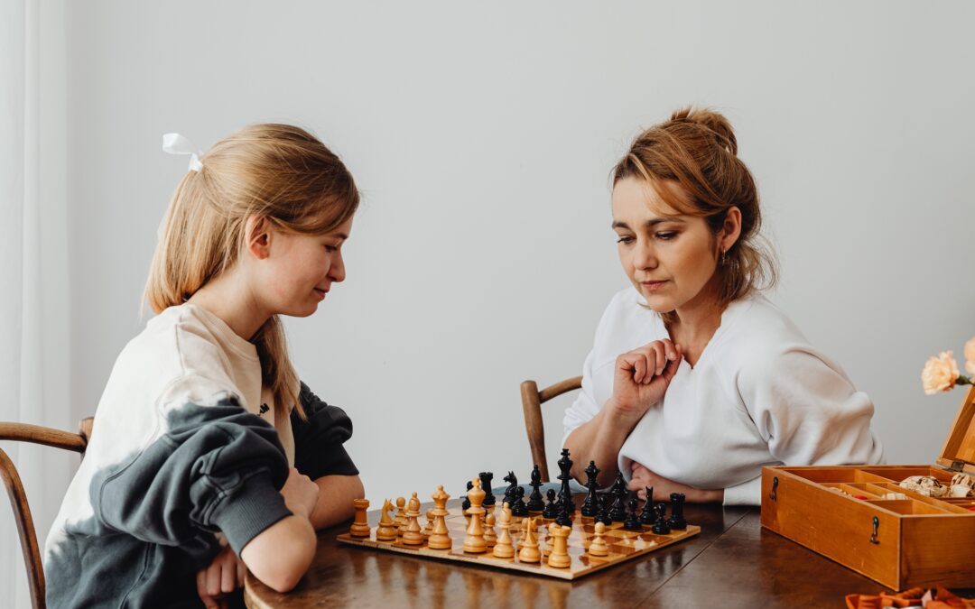 mother and daughter playing chess